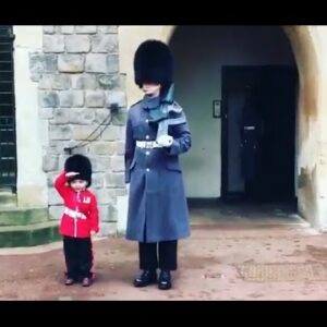 Boy Dressed as British Guard Salutes Windsor Fortress Troopers