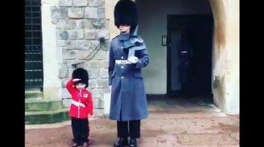 Boy Dressed as British Guard Salutes Windsor Fortress Troopers