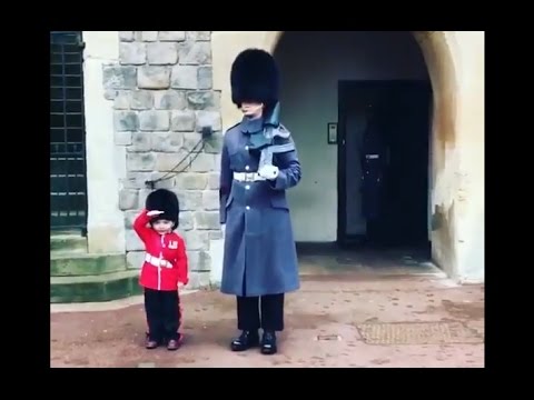 Boy Dressed as British Guard Salutes Windsor Fortress Troopers